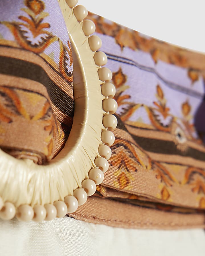 crema con stampa floreale e pantaloncini con cintura